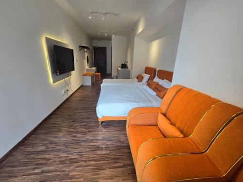 a living room with a bed and a couch at K Avenue Sunset View Condomonium - Kota Kinabalu Airport in Kota Kinabalu