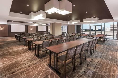 a conference room with tables and chairs and windows at Residence Inn by Marriott Charlotte City Center in Charlotte