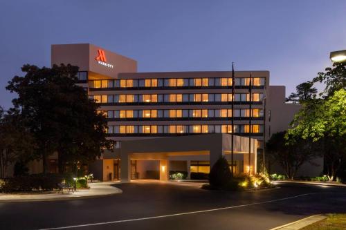 an office building with a lit up facade at night at Marriott Raleigh Durham Research Triangle Park in Durham
