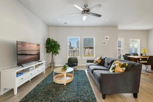 a living room with a couch and a flat screen tv at Beautiful spacious house with great location! in Conroe