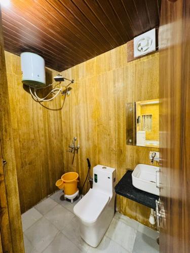 a bathroom with a toilet and a sink at Silent Sands Jaisalmer in Jaisalmer