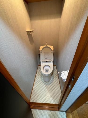 a small bathroom with a toilet in a small room at Ema eve HOUSE in Tokyo