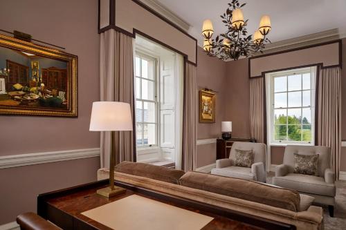 a living room with a couch and two chairs at The Langley, a Luxury Collection Hotel, Buckinghamshire in Iver