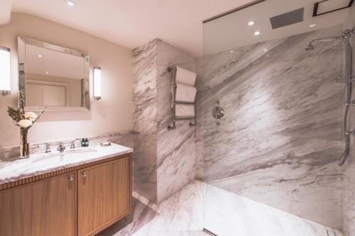 a bathroom with a sink and a shower at The Langley, a Luxury Collection Hotel, Buckinghamshire in Iver