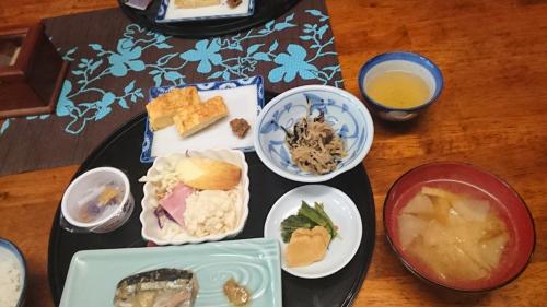 a table topped with plates of food on a table at Lodge Amenouo in Myoko