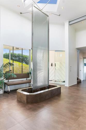 a large glass shower in a large room at Luxury Hilltop Villa with Breathtaking Views- Perfect for Family Stays & Events in Waiwera
