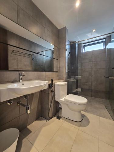 a bathroom with a toilet and a sink at K Avenue Sunset View Condomonium - Kota Kinabalu Airport in Kota Kinabalu