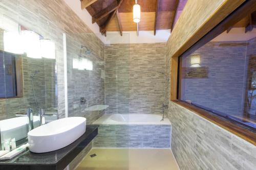 
a bathroom with two sinks and a large mirror at Sol Beach Resort in Koh Rong Sanloem
