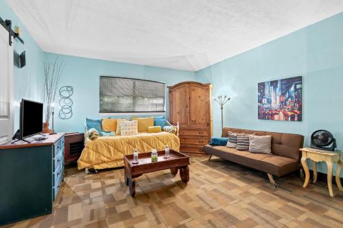a living room with a bed and a couch at Blue Bell Apartment Hotel in Fort Lauderdale