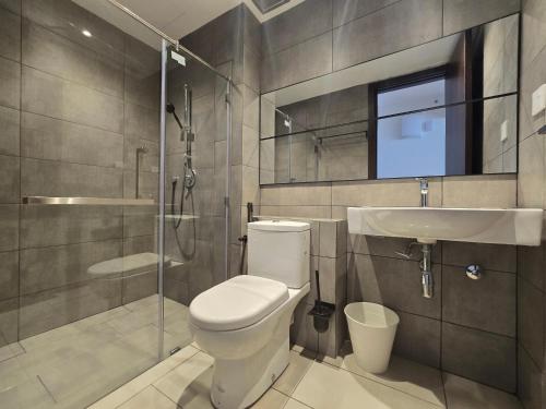 a bathroom with a toilet and a sink and a shower at K Avenue Sunset View Condomonium - Kota Kinabalu Airport in Kota Kinabalu