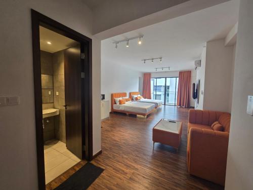 a large living room with a couch and a bed at K Avenue Sunset View Condomonium - Kota Kinabalu Airport in Kota Kinabalu
