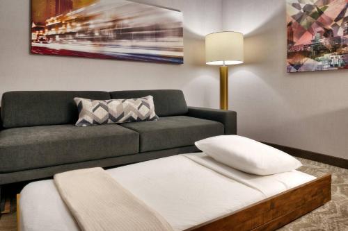 a living room with a couch and a table at SpringHill Suites By Marriott Salt Lake City West Valley in West Valley City