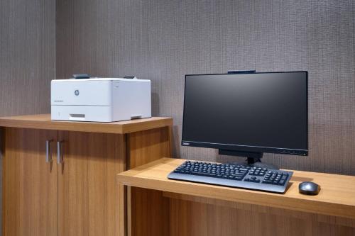 a computer monitor and a keyboard and mouse on a desk at SpringHill Suites By Marriott Salt Lake City West Valley in West Valley City