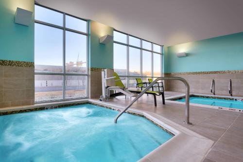 a hot tub in a hotel room with a view at SpringHill Suites By Marriott Salt Lake City West Valley in West Valley City