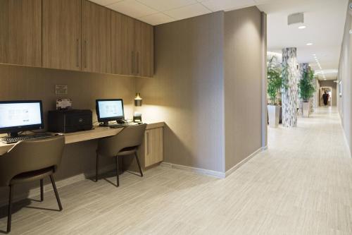 an office with two computers on a desk with chairs at SpringHill Suites by Marriott Somerset Franklin Township in Somerset