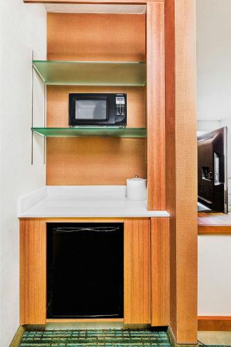 a microwave sitting on top of a counter in a kitchen at Springhill Suites by Marriott Anaheim Maingate in Anaheim
