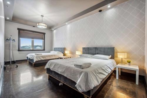 a large bedroom with two beds and a window at Luxurious Modern 11-Bed Home Private 136 Acres in Spruce Grove