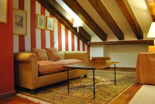 a living room with a couch and a table at El Hotel De La Villa in Pedraza-Segovia
