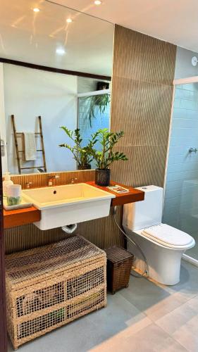a bathroom with a sink and a toilet at Sun House Manguinhos in Búzios