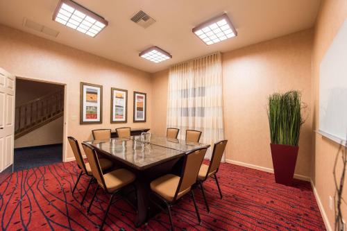 a conference room with a table and chairs at Residence Inn Palm Desert in Palm Desert