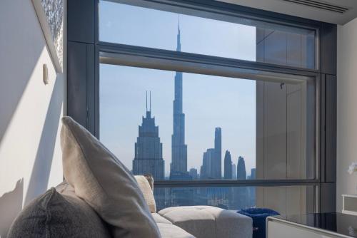 a window with a view of the chicago skyline at Stunning Burj Khalifa & Downtown Views - Elegant 1BR in The Iconic Index Tower in Dubai