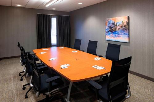 a conference room with a large wooden table and chairs at SpringHill Suites by Marriott Salt Lake City Airport in Salt Lake City