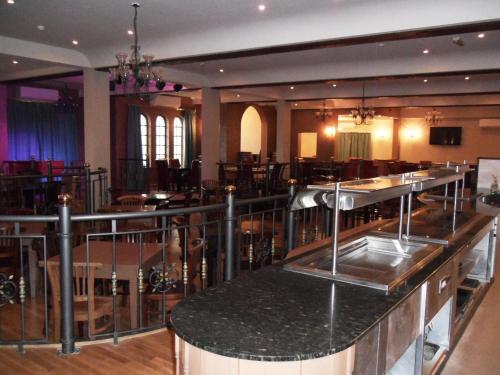 a restaurant kitchen with stainless steel counter tops at Skylark Hotel in Southend-on-Sea
