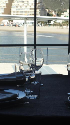 a glass chair sitting on a table with a view of the ocean at Hotel Marina in Oropesa del Mar