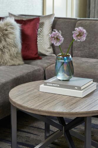 a vase on top of a book on a table at Rochester Airport Marriott in Rochester