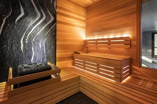 a sauna with a bench in a wooden room at Hotel Ivy, a Luxury Collection Hotel, Minneapolis in Minneapolis