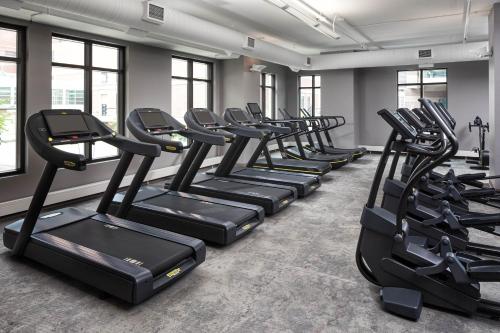 a row of treadmills in a gym with windows at Hotel Ivy, a Luxury Collection Hotel, Minneapolis in Minneapolis