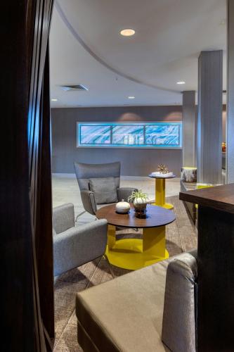a living room with a couch and a table at SpringHill Suites by Marriott Salt Lake City Downtown in Salt Lake City