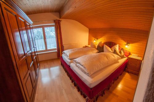 a bedroom with a large bed in a room at Pension Alwin in Lech am Arlberg