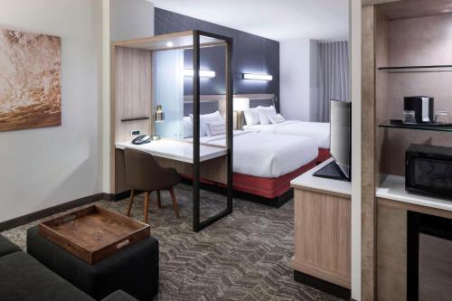 a hotel room with a bed and a desk at SpringHill Suites by Marriott Clearwater Beach in Clearwater Beach