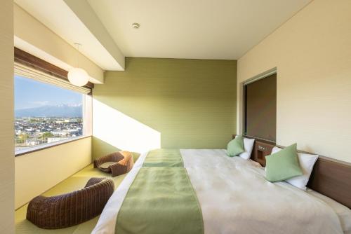 Ένα ή περισσότερα κρεβάτια σε δωμάτιο στο Tsukino HOTEL