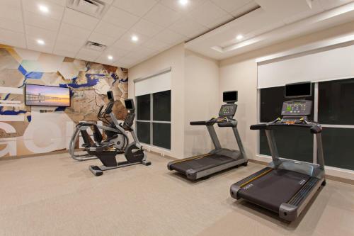 a gym with two treadmills and two exercise bikes at SpringHill Suites by Marriott Huntington Beach Orange County in Huntington Beach