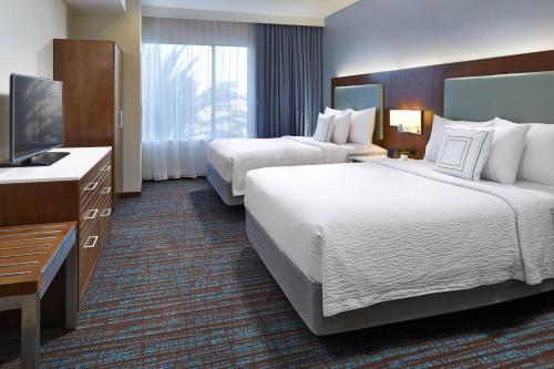 a hotel room with two beds and a television at SpringHill Suites by Marriott at Anaheim Resort Area/Convention Center in Anaheim