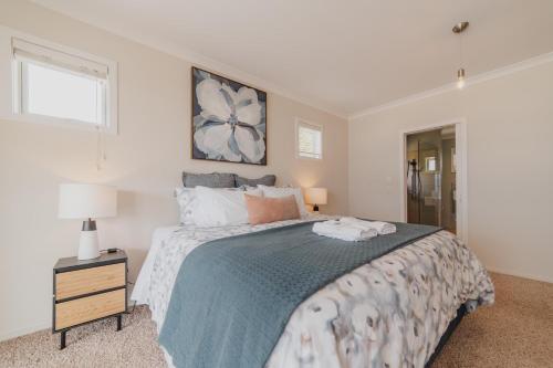 a bedroom with a large bed and a window at Starlight Lakeview Vista - 5BR Hideaway & Hot Tub in Lake Tekapo