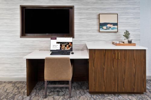 a computer desk with a monitor and a laptop on it at Residence Inn Columbus in Columbus