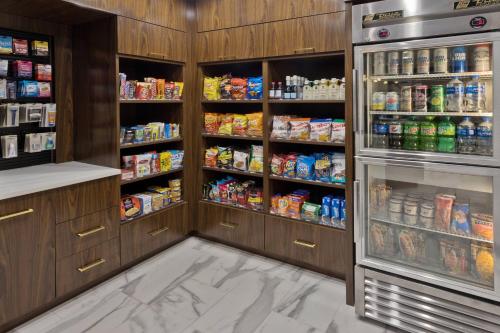 a kitchen with a refrigerator filled with lots of food at Residence Inn Columbus in Columbus