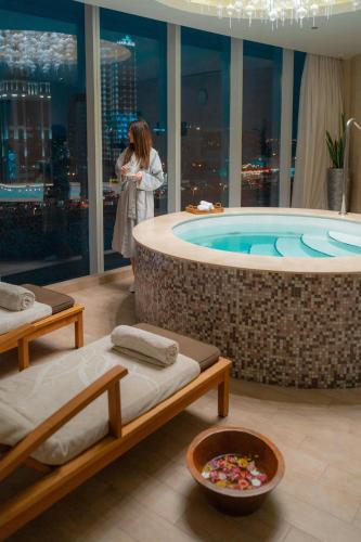 a woman standing in a bath tub in a building at JW Marriott Hotel Riyadh in Riyadh