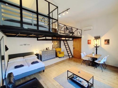 a bedroom with a loft bed and a living room at MOOKI Rumbach Budapest Apartment in Budapest
