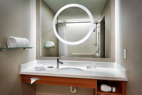 a bathroom with a sink and a large mirror at SpringHill Suites by Marriott Provo in Provo