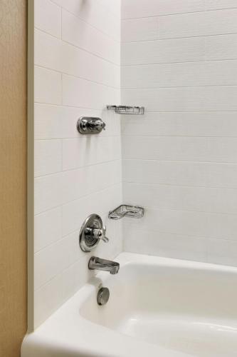 a white shower with two faucets and a sink at SpringHill Suites by Marriott Provo in Provo