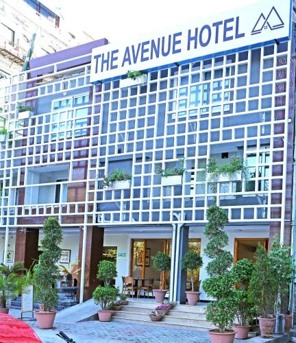 a hotel with a sign that reads the avenue hotel at The Avenue Hotel in Islamabad