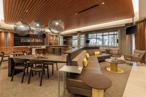 a lobby with a couch and a table and chairs at SpringHill Suites by Marriott Tallahassee North in Tallahassee