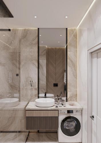 a bathroom with a sink and a washing machine at NestOne Apartment 39th floor in Tashkent