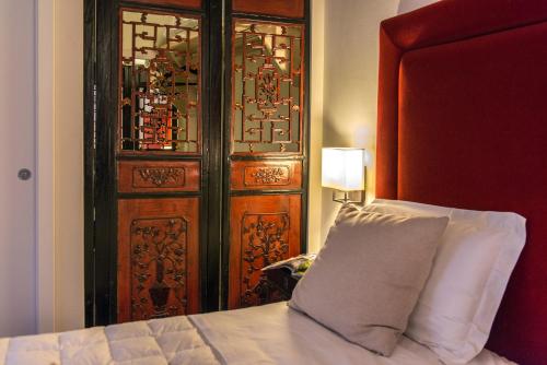 a bedroom with a bed and a door at Cortona Resort & Spa - Villa Aurea in Cortona