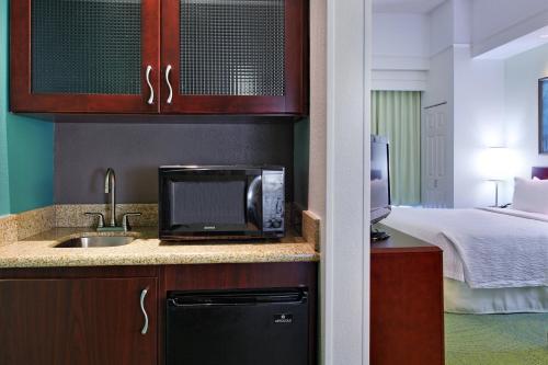 a hotel room with a sink and a bed at SpringHill Suites Knoxville At Turkey Creek in Knoxville
