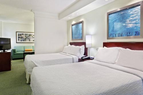 a hotel room with two beds and a tv at SpringHill Suites Knoxville At Turkey Creek in Knoxville